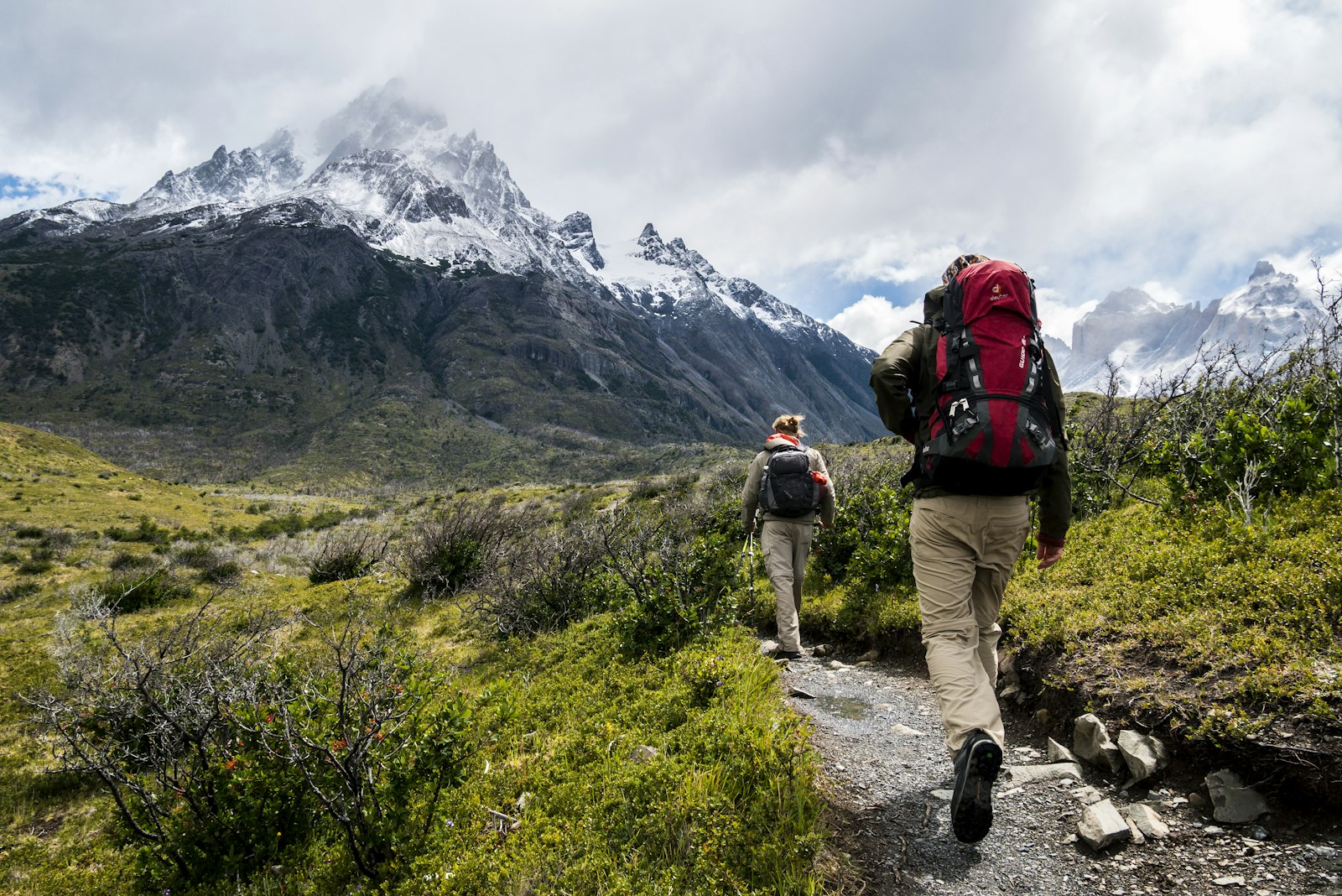 Backpackers hiking a mountain trail near a campsite
